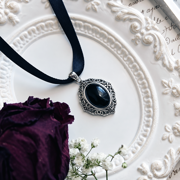 Vintage onyx pendant styled with a satin choker.